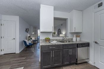 Kitchen area with wooden flooring and appliances